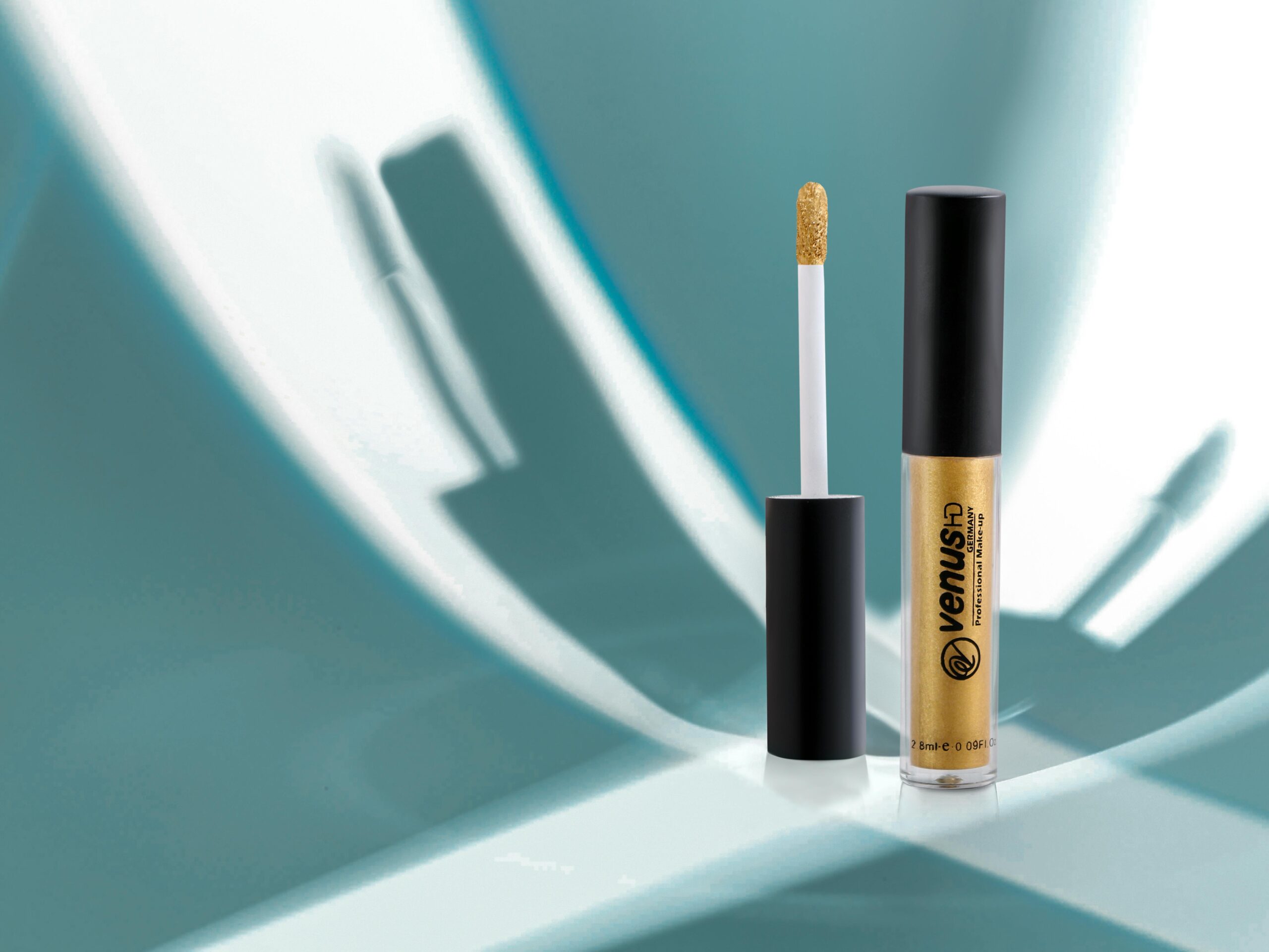 A close-up of elegant gold lip gloss with a modern, minimalist background. Ideal for beauty and fashion themes.