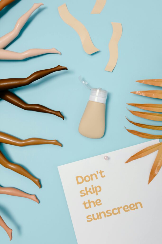 Flat lay of diverse skin tones with sunscreen message.