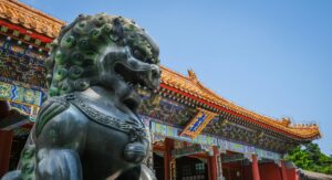 Close view of Foo Dog statue and traditional Chinese architecture at Beijing's Summer Palace.