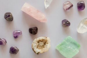 Flat lay of various gemstones on a white surface, showcasing color and texture.