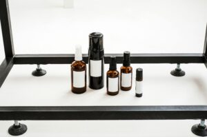 A minimalist still life photography of various aromatherapy bottles on a white table.